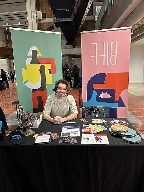 Nico Doret'24 at a booth for the Beloit International Film Festival